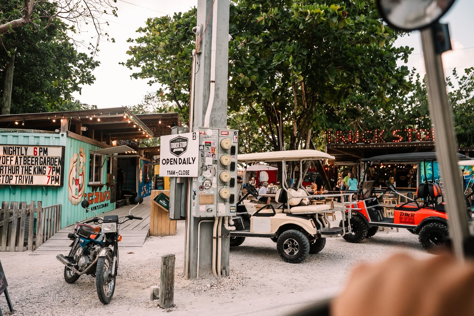 The view from the driver's seat of a golf cart on a San Pedro street